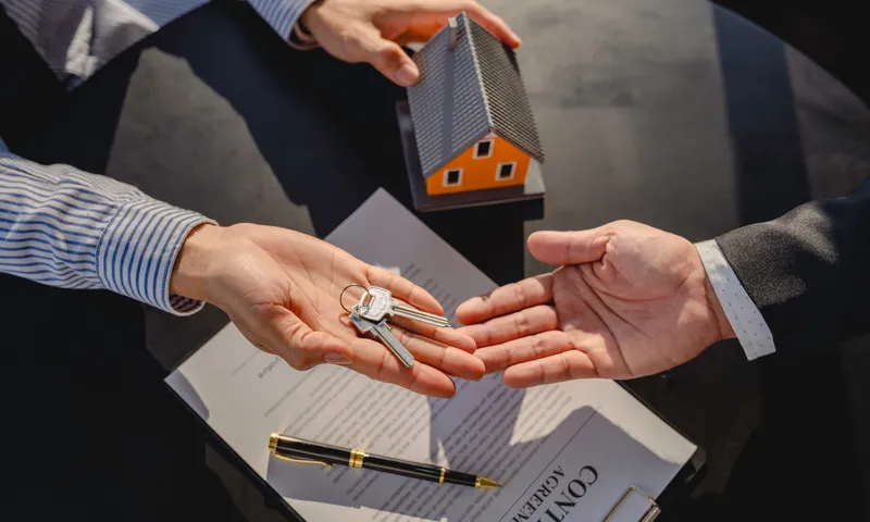 Happy family receiving keys to a home in Bethany Beach, Delaware